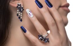 woman-with-nail-art-promoting-design-luxury-earrings-ring